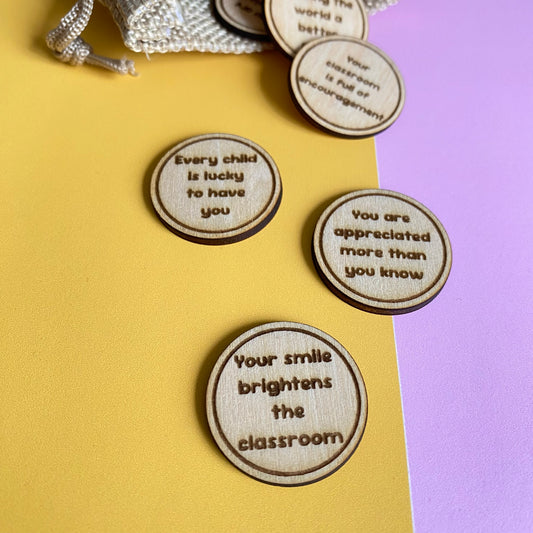 Teacher appreciation affirmation tokens engraved on wooden discs presented in a reusable drawstring gift bag.