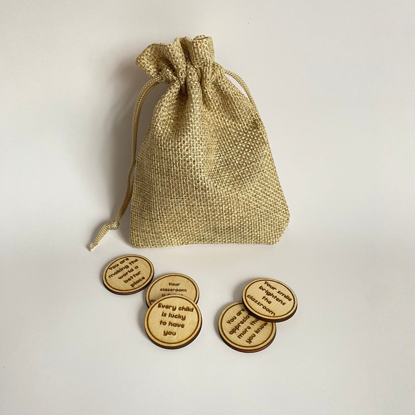 Handmade wooden teacher thank you affirmation tokens engraved with positive messages for teachers.